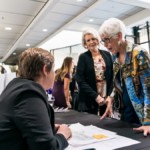 Shows an event attendee checking into a tradeshow