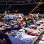 Shows tables with luxurious decor ready for the crowd at SaveMart Center